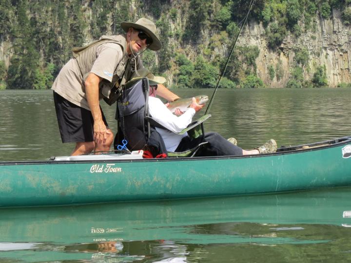 Blair assisting Richard with a fine rainbow trout