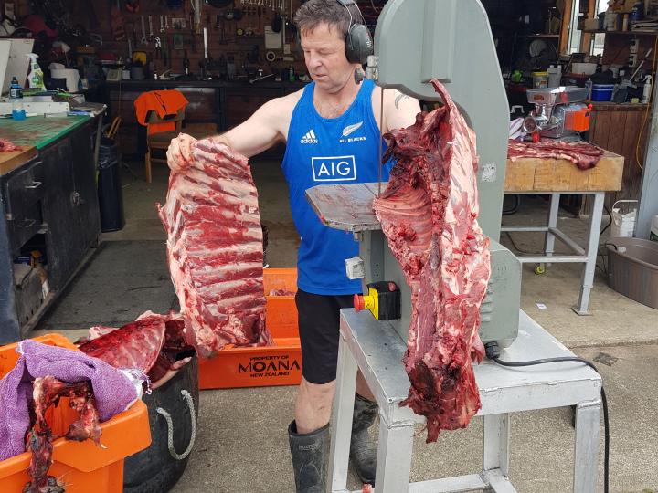Steve cutting ribs with the ban saw