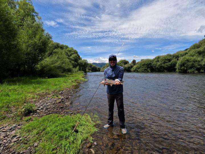 Rainbow on a net building caddis nymph