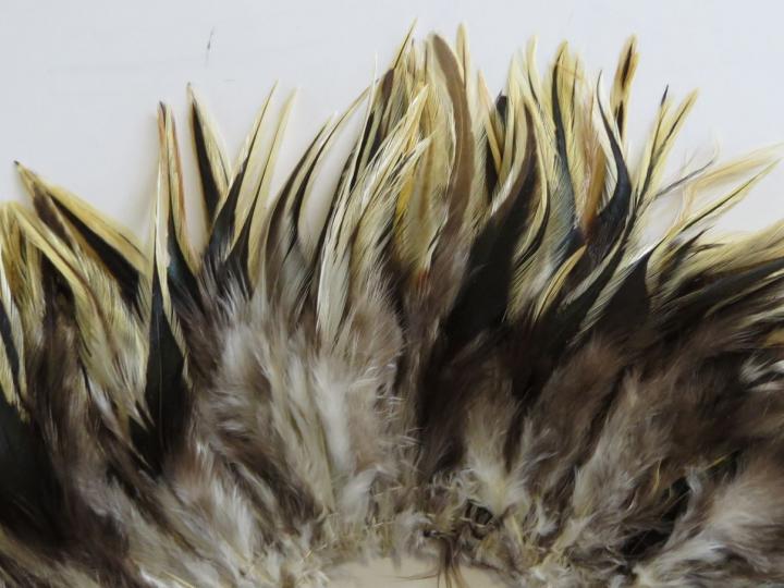 Badger Saddle Strung Feathers Closeup