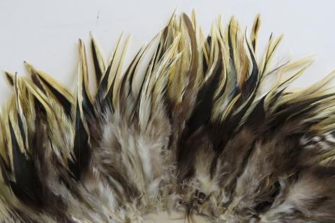 Badger Saddle Strung Feathers Closeup