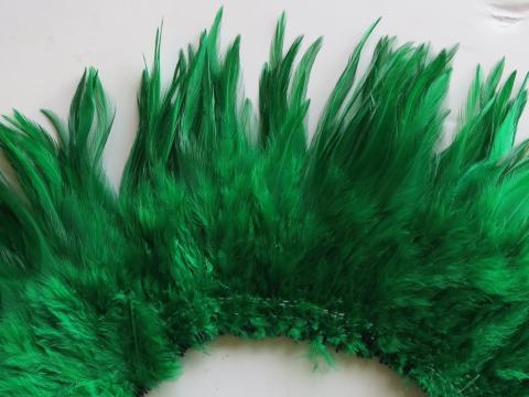 Strung green saddle feathers closeup