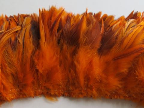 Orange caramel cream strung feathers closeup